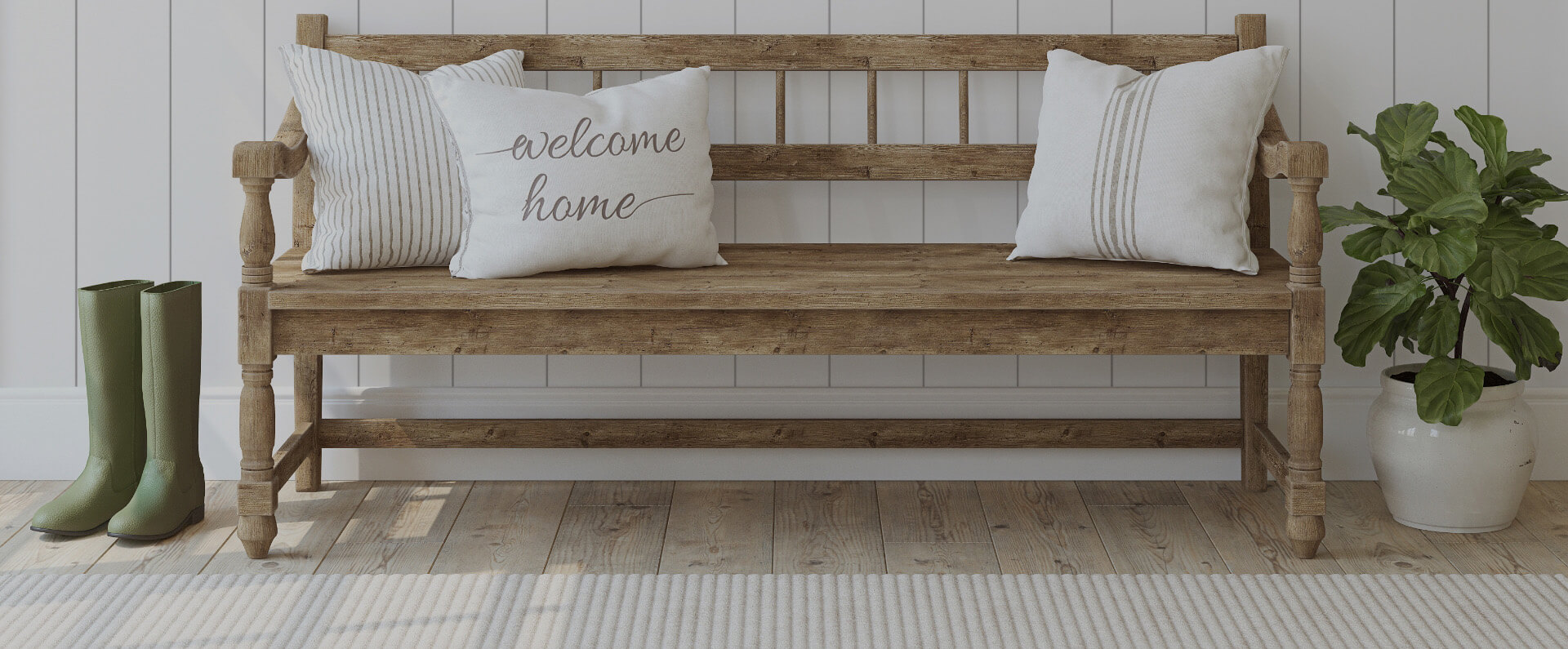 Entry way with bench and pillows that read Welcome Home