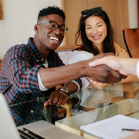 Couple shaking hands with loan officer after pre approval