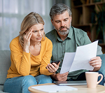 Young couple looking over mortgage documents